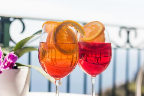 two wine glasses with orange slices in them at Via Col Vento in Ravello