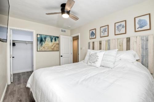 a bedroom with a white bed and a ceiling fan at Tower 9 D in Oceanside