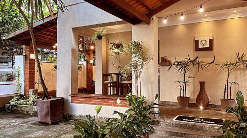 a house with potted plants on the front of it at Hotel Rio in Guarujá