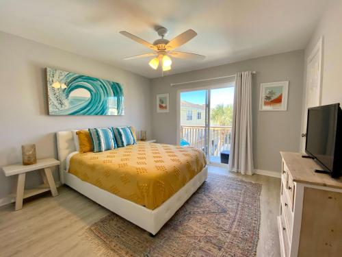a bedroom with a bed and a flat screen tv at Sand Dollar 2 by ALBVR - Walking distance to Hangout! Beautifully redone condo! in Gulf Shores