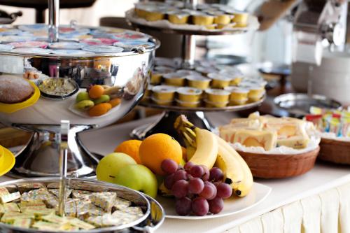 a buffet filled with different types of food on a table at Hotel Dei Fiori in Milan