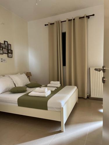 a bedroom with a bed with towels on it at Myrthe Apartments in Myrtos