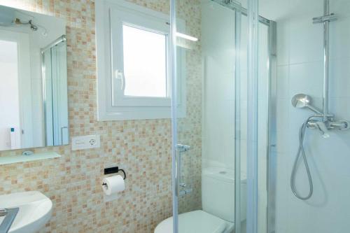 a bathroom with a shower and a toilet and a sink at Camping Urbion in Abejar