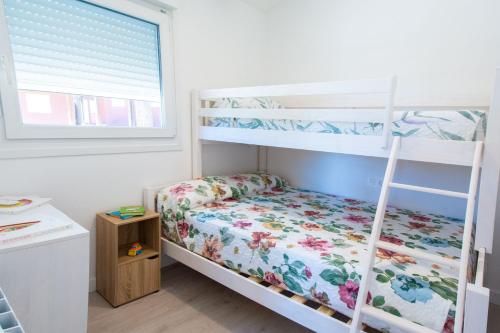 a bedroom with two bunk beds and a window at Camping Urbion in Abejar