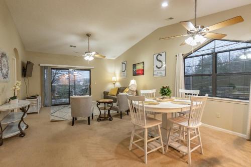 a dining room and living room with a table and chairs at 2BR Penthouse Condo - 2 Pools - Close to the Strip - Stairs Required - FREE TICKETS INCLUDED - FHC-24 in Branson