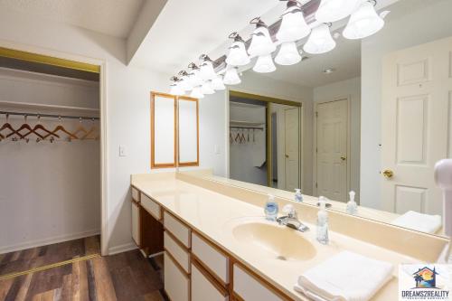 a bathroom with a sink and a large mirror at 2BR Walk-In Condo - Near the 76 Strip - 2 Pools - FREE TICKETS INCLUDED - FHD-8 in Branson