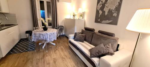 a living room with a couch and a table at SeaYouSoon Inn Cannes - Studios in Cannes
