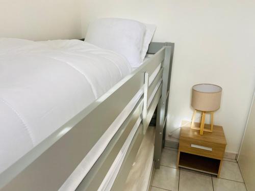 a bedroom with a bed and a side table at La mer qu’on voit danser…. in Cayeux-sur-Mer
