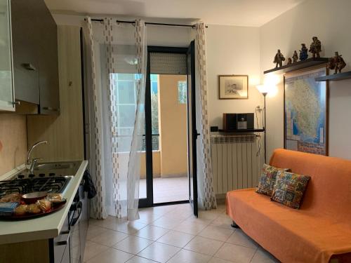 a kitchen with a couch and a kitchen with a stove at La Dimora di Paola in Lecce