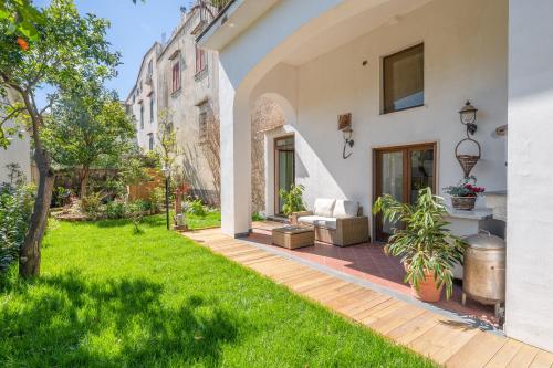 uma casa com um quintal com relva verde em Maison Le Graziose em Sant'Agnello
