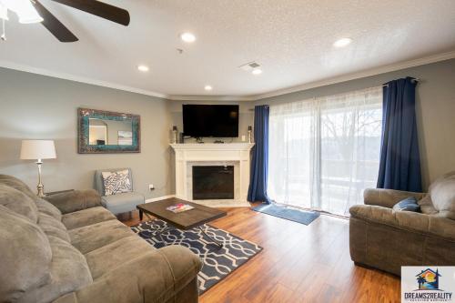a living room with a couch and a fireplace at 2BR Updated Condo - Close to the Strip - Stairs Required - 2 Pools - FREE TICKETS INCLUDED - FHE-3 in Branson