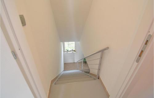 a staircase in a white room with a window at Casa Pra Bene Vagienna in Bene Vagienna