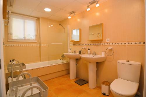 La salle de bains est pourvue de toilettes, d'un lavabo et d'une baignoire. dans l'établissement Precioso Duplex frente al mar en Campoamor Alicante, à Campoamor