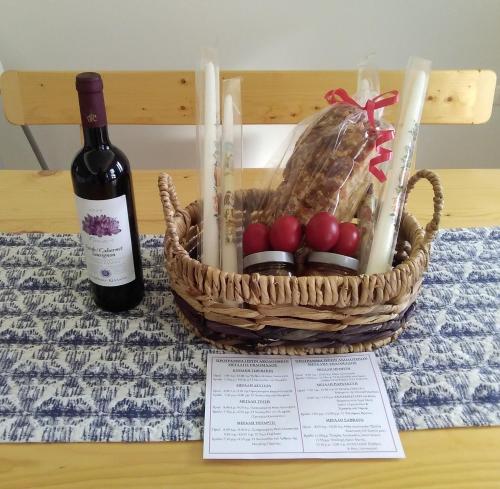 a basket of apples and a bottle of wine at PRINCESS OF BLUE EAGLES RETREAT in Skaloma