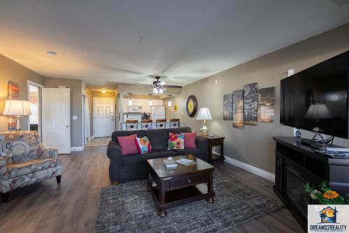 a living room with a couch and a tv at 2BR Walk-In Condo - Near the 76 Strip - Pool - FREE TICKETS INCLUDED - CLC-6 in Branson