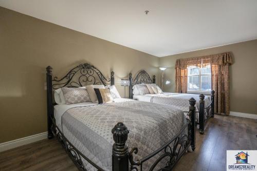 a bedroom with two beds and a window at 2BR Walk-In Condo - Near the 76 Strip - Pool - FREE TICKETS INCLUDED - CLC-6 in Branson