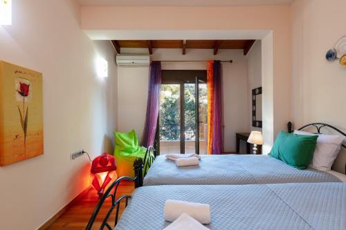 a bedroom with two beds and a window at Family Villa Ellis Plakias with private pool 200m to the beach walking distance to the amenities in Plakias