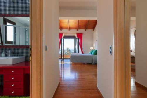 a bathroom with a sink and a bed in a room at Family Villa Ellis Plakias with private pool 200m to the beach walking distance to the amenities in Plakias