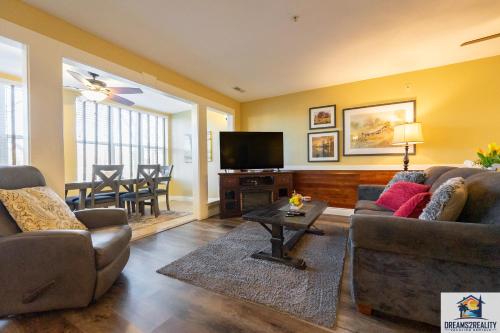 a living room with two couches and a television at 2BR Walk-In Condo - Near the 76 Strip - Pool - FREE TICKETS INCLUDED - CLC-7 in Branson