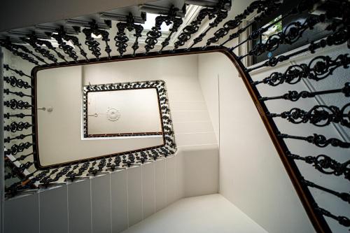 a staircase with a mirror on the wall at Halpin House (South Kensington) in London