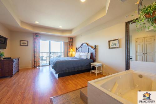 a bedroom with a bed and a tub at 1BD King Condo with 2 Person Jacuzzi Tub - Near The Strip - FREE TICKETS INCLUDED - T1-9 in Branson