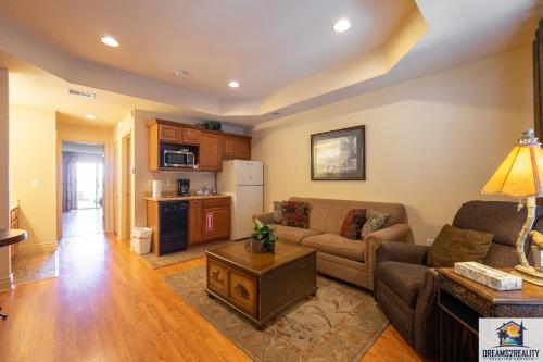 a living room with a couch and a table at 1BD King Condo with 2 Person Jacuzzi Tub - Near The Strip - FREE TICKETS INCLUDED - T1-9 in Branson