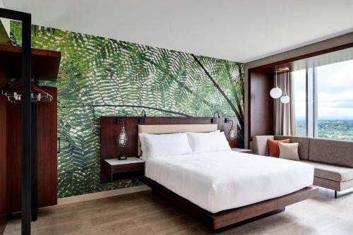 a bedroom with a large bed and a couch at Marriott Santa Cruz de la Sierra Hotel in Santa Cruz de la Sierra
