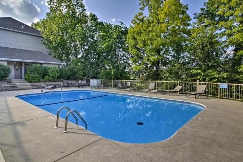 a blue swimming pool with chairs and a fence at 1BD King Condo with 2 Person Jacuzzi Tub - Near The Strip - FREE TICKETS INCLUDED - T1-9 in Branson