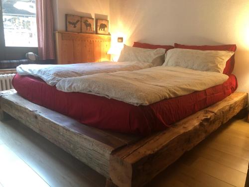 a bed on a wooden platform with at house of hearts - CIR10 in La Thuile