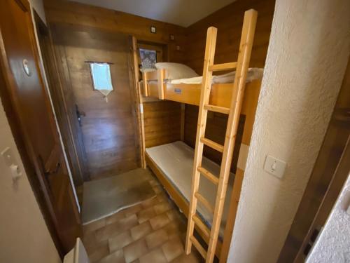 a small room with a bunk bed and a ladder at Chaleureux studio avec balcon Sud/Ouest à 500m du centre, parking et à deux pas des remontées! - FR-1-693-54 in Châtel