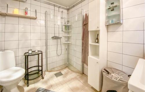 a white bathroom with a shower and a toilet at Nice Home In Skene With Kitchen in Skene