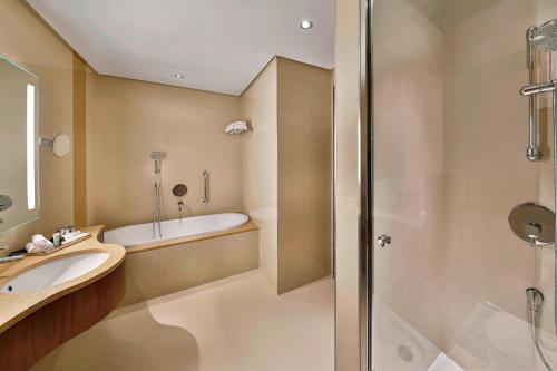 a bathroom with a sink and a shower at Courtyard by Marriott Riyadh Olaya in Riyadh
