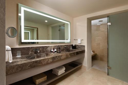 a bathroom with a sink and a mirror and a shower at NUMU Boutique Hotel, The Unbound Collection by Hyatt in San Miguel de Allende