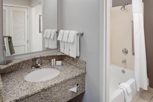 a bathroom with a sink and a mirror at Courtyard Fort Worth I-30 West Near NAS JRB in Fort Worth