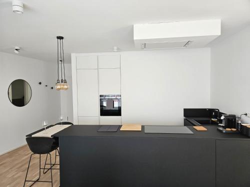 una cocina con una isla negra en una habitación en New Spacious Two Bedroom Center with Parking, near Public Transport en Luxemburgo