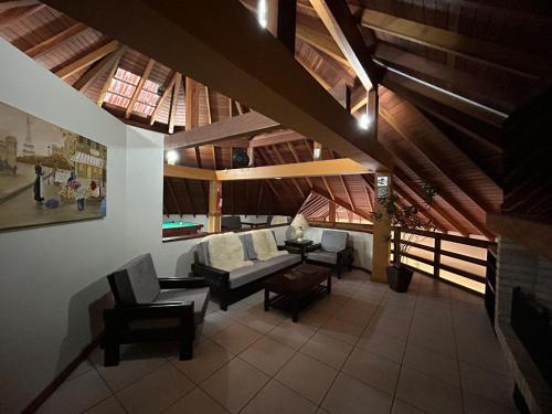 a living room with a couch and chairs and a table at Pousada Villa Verde in Canela