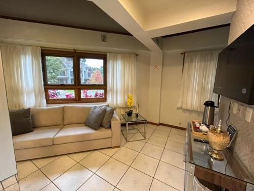a living room with a couch and a window at Pousada Villa Verde in Canela