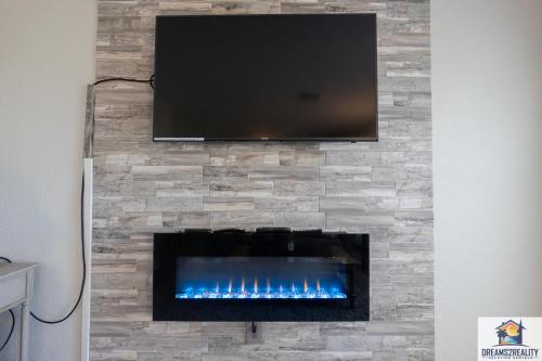 a fireplace with a tv on a stone wall at 1BR Walk-In Condo at Pointe Royal - 2 Pools - FREE TICKETS INCLUDED - PR40-9 in Branson
