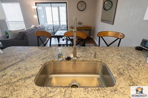 a kitchen with a sink and a living room at 1BR Walk-In Condo at Pointe Royal - 2 Pools - FREE ATTRACTIONS TICKETS INCLUDED -PR40-9 in Branson