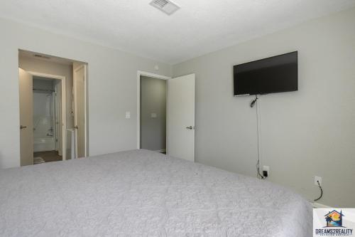 a bedroom with a bed and a flat screen tv at 1BR Walk-In Condo at Pointe Royal - 2 Pools - FREE TICKETS INCLUDED - PR40-9 in Branson