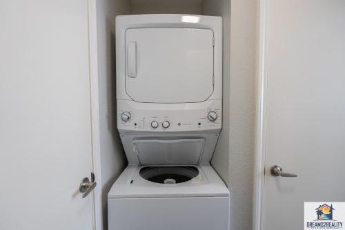 a computer sitting on top of a washing machine at 1BR Walk-In Condo at Pointe Royal - 2 Pools - FREE TICKETS INCLUDED - PR40-9 in Branson