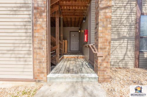 a brick house with a door leading to a porch at 1BR Walk-In Condo at Pointe Royal - 2 Pools - FREE ATTRACTIONS TICKETS INCLUDED -PR40-9 in Branson