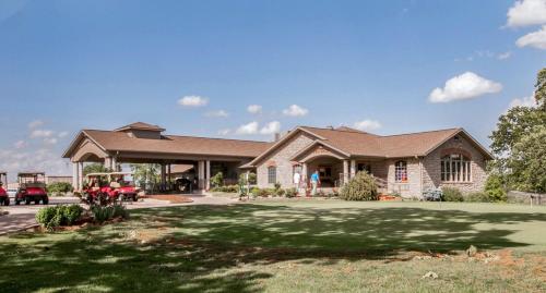 a large brick house with a large yard at 1BR Walk-In Condo at Pointe Royal - 2 Pools - FREE TICKETS INCLUDED - PR40-9 in Branson