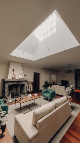 a living room with a couch and a fireplace at Chalet De La Croix in Vila Franca do Campo