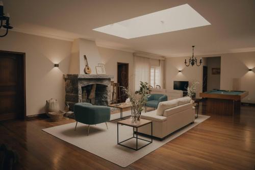 a living room with a couch and a fireplace at Chalet De La Croix in Vila Franca do Campo