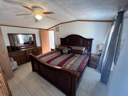 a bedroom with a bed and a ceiling fan at Bloomington's Cozy Model Home in Bloomington