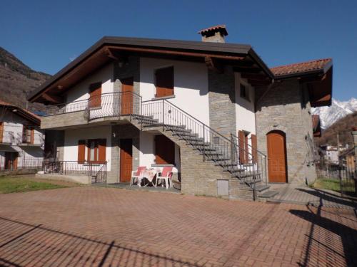 a large house with a balcony and a patio at Casa Vacanza Dal Contadino CIR O17063 in Alpe Strencia