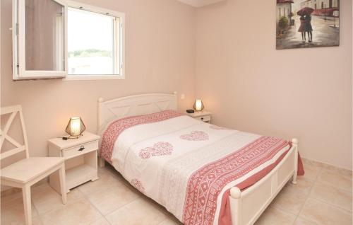 a white bedroom with a bed and a window at Beautiful Home In Barjac With Swimming Pool in Barjac