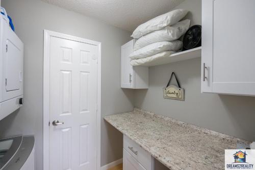 a kitchen with white cabinets and a counter with towels at 1BR Walk-In Condo at Pointe Royal - 2 Pools - FREE ATTRACTION TICKETS INCLUDED -PR42-16 in Branson