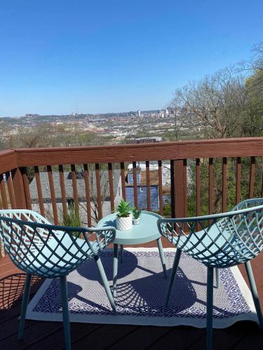 a table and two chairs on a balcony with a view at Downtown Views-Prime Location! in Cincinnati